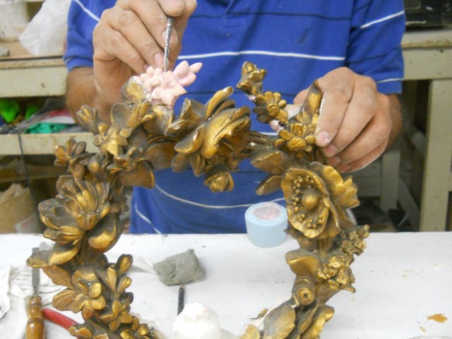 Gilding of floral element on a frame restoration