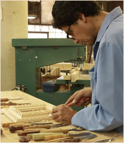 A skilled craftsman working on a replica frame