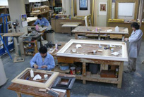 Various experts working in the frame restoration studio